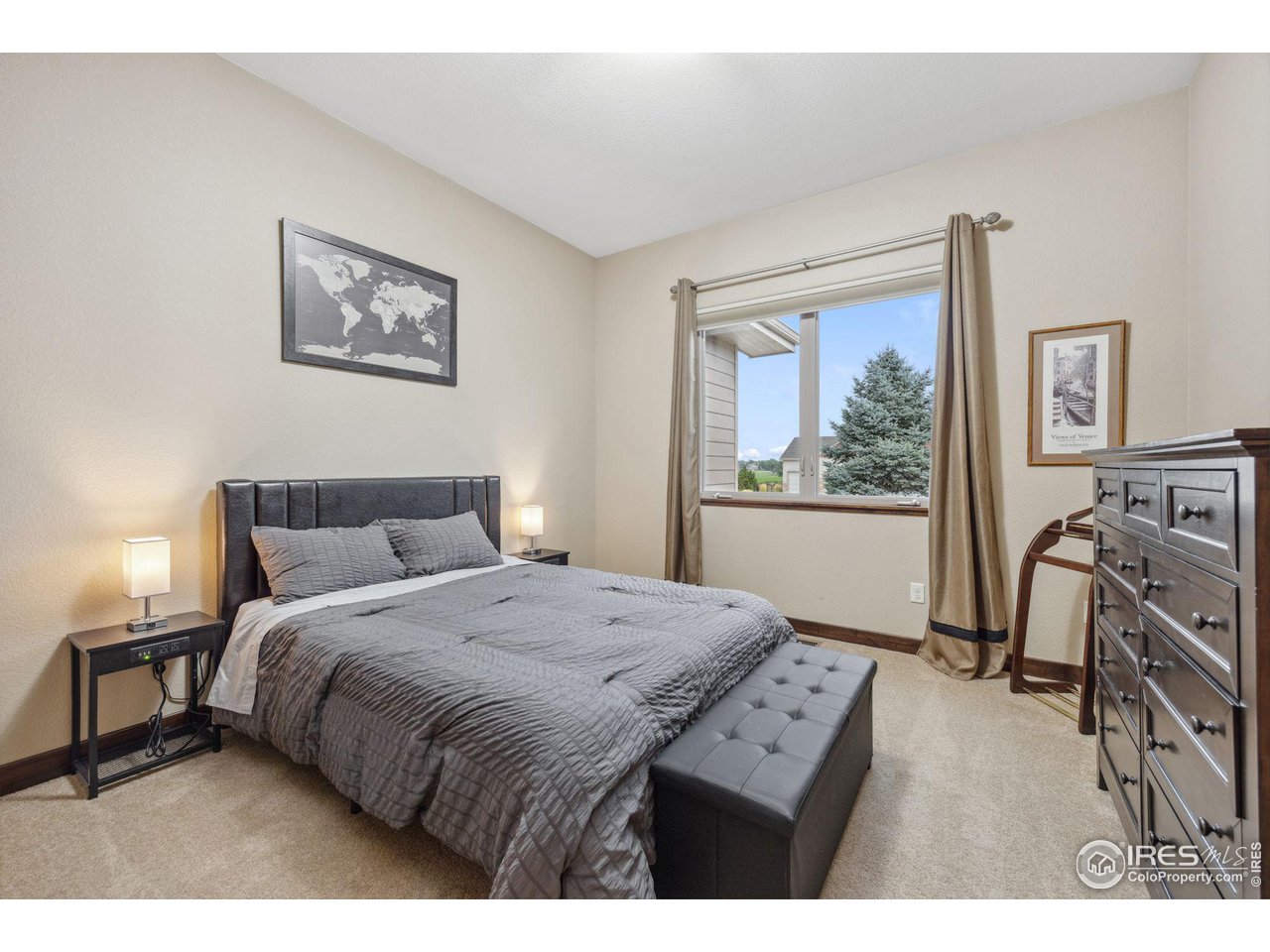 6178 Bay Meadows Drive Windsor, CO 80550 - Photo 24 of 40 a bedroom with a bed a couch and a window