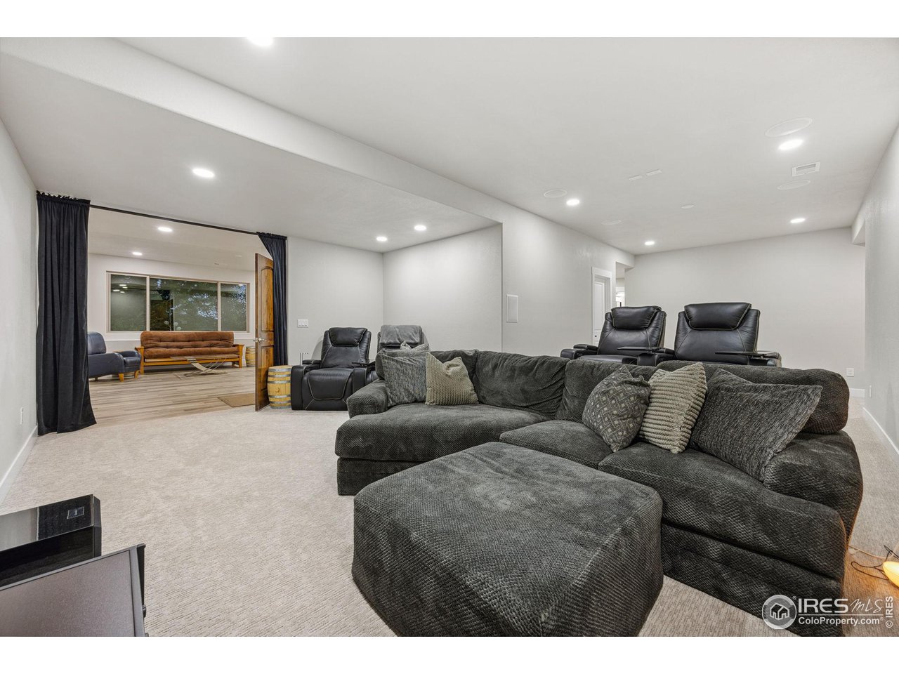 6178 Bay Meadows Drive Windsor, CO 80550 - Photo 26 of 40 a living room with furniture and a view of kitchen