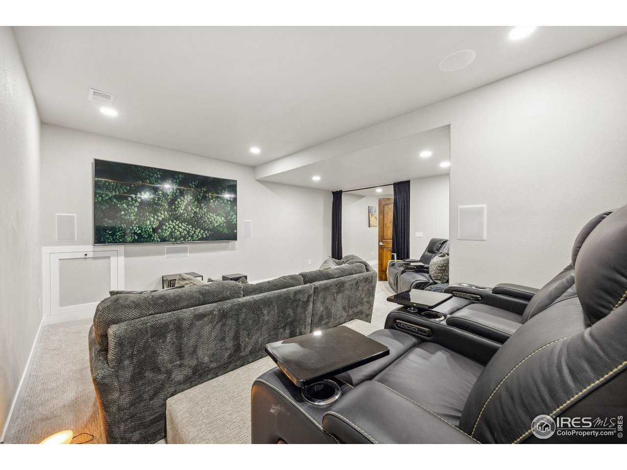 6178 Bay Meadows Drive Windsor, CO 80550 - Photo 27 of 40 a living room with furniture and a flat screen tv