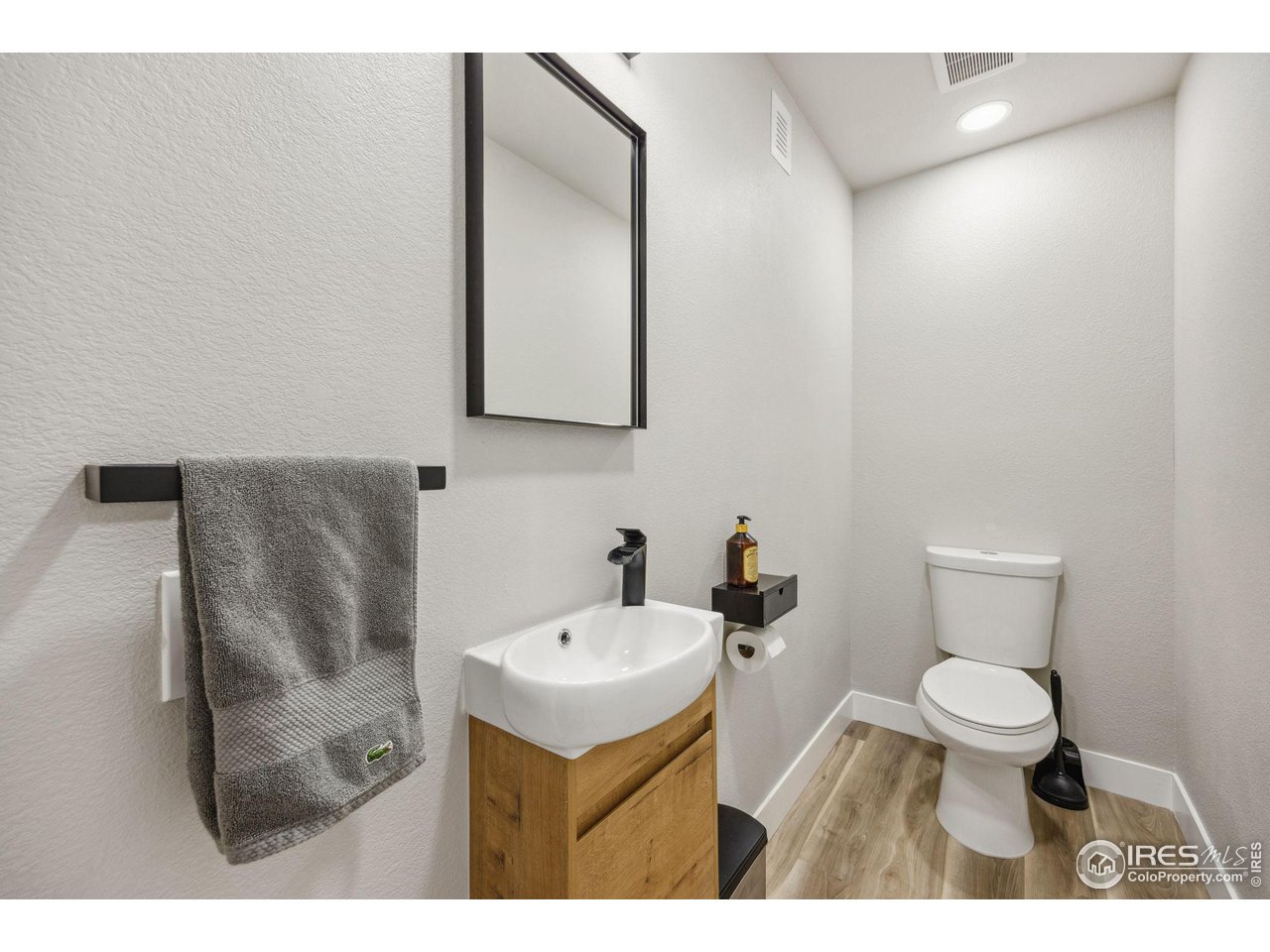 6178 Bay Meadows Drive Windsor, CO 80550 - Photo 32 of 40 a bathroom with a sink toilet and a mirror