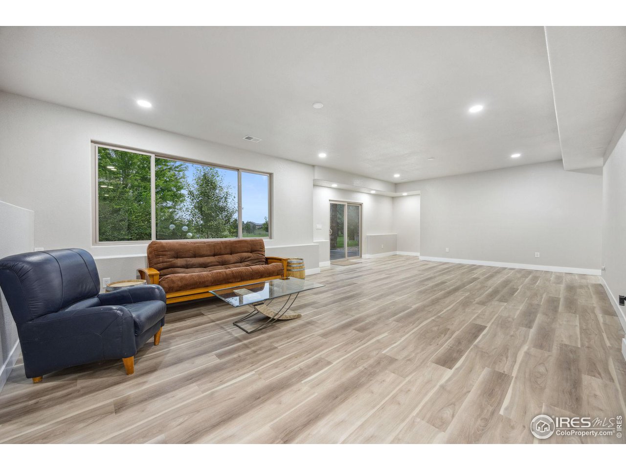 6178 Bay Meadows Drive Windsor, CO 80550 - Photo 34 of 40 a living room with furniture and a yard