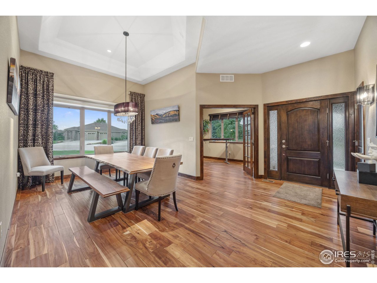 6178 Bay Meadows Drive Windsor, CO 80550 - Photo 9 of 40 a view of a dining room with furniture window and wooden floor