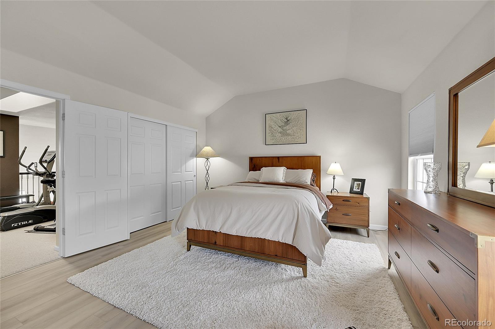 6539 Trailhead Road Highlands Ranch, CO 80130 - Photo 18 of 30 a bedroom with a bed and wooden floor