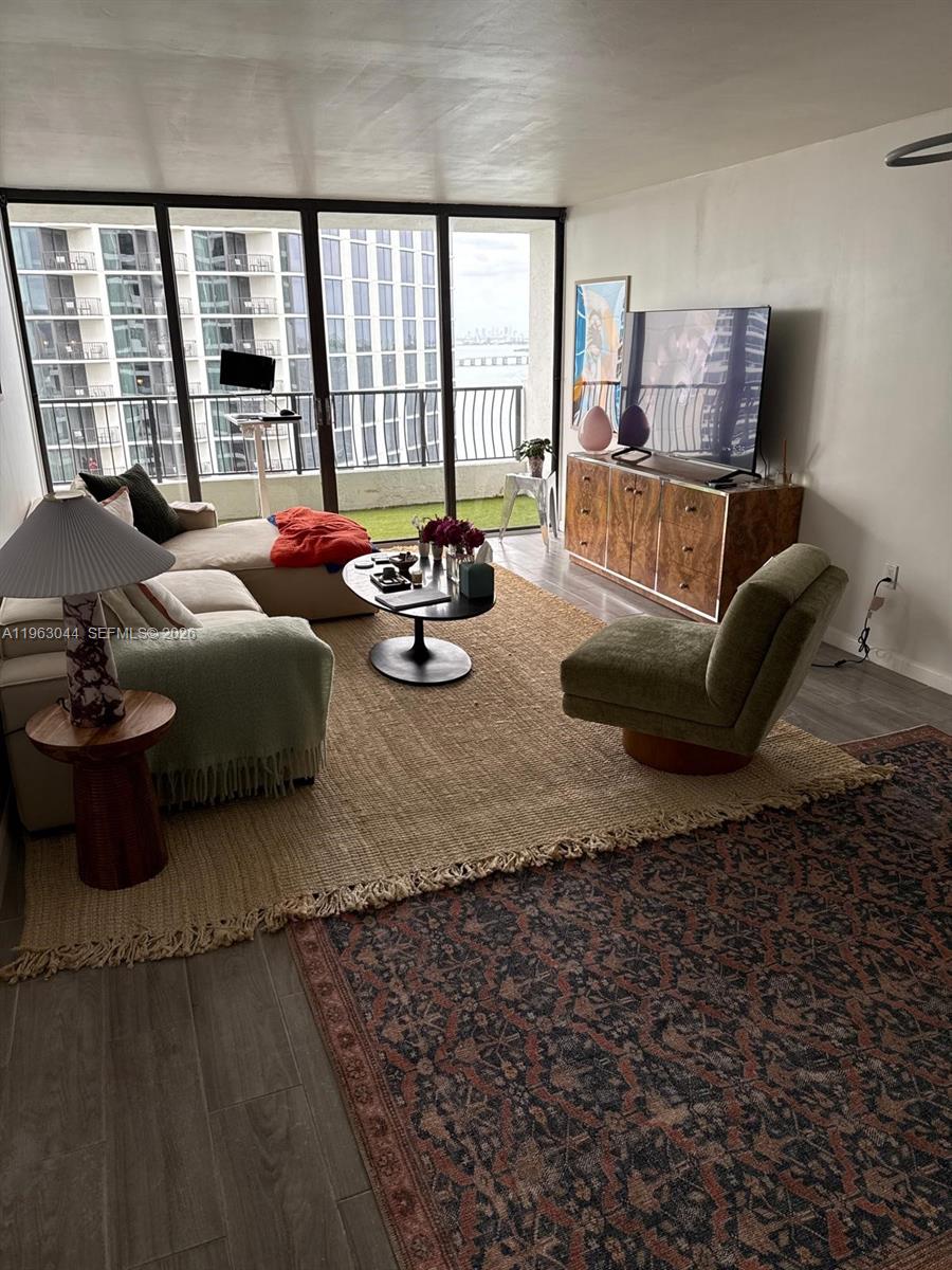 555 Northeast 15th Street, Unit 29G Miami, FL 33132 - Photo 2 of 11 a living room with furniture and a floor to ceiling window