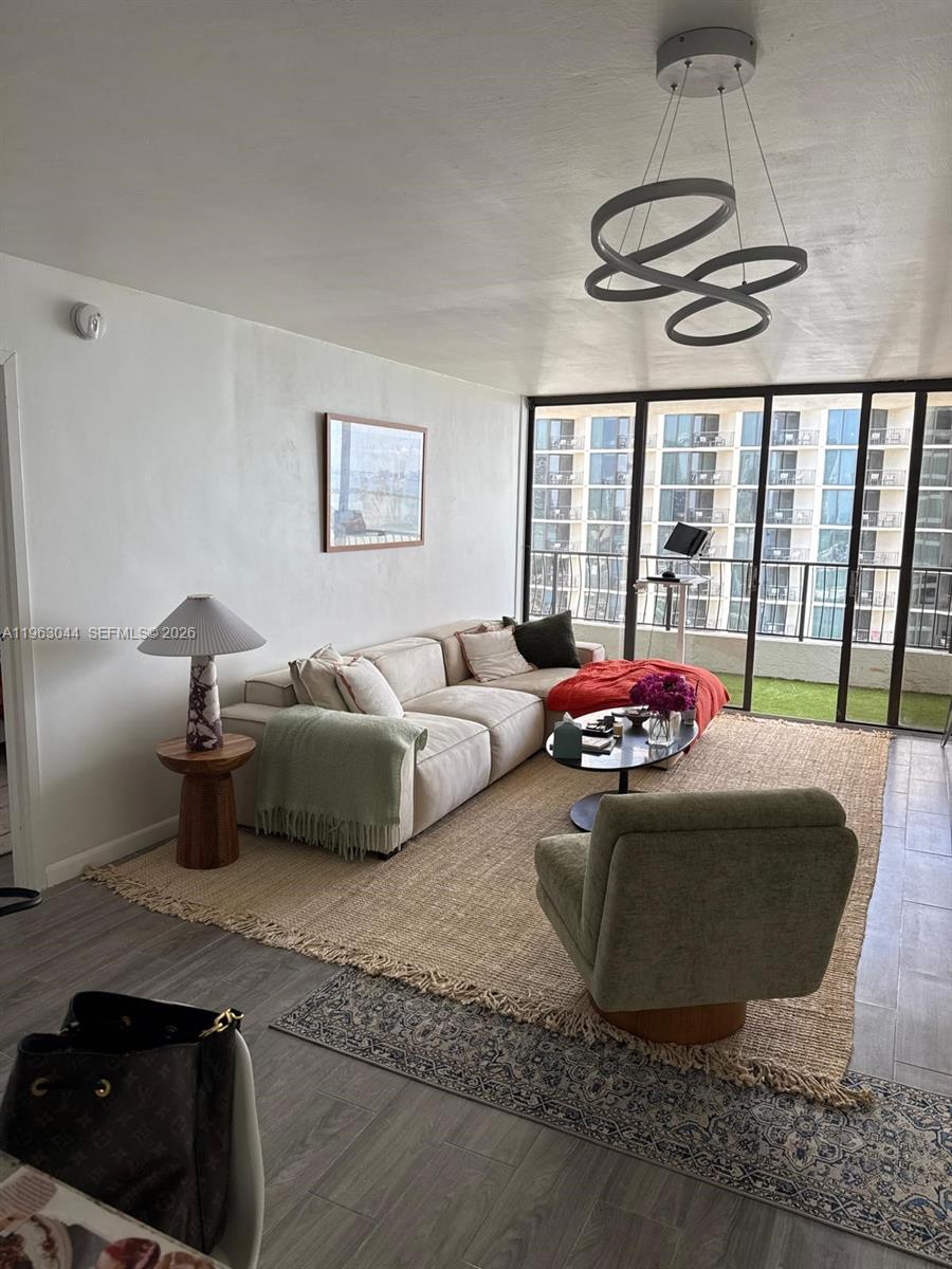 555 Northeast 15th Street, Unit 29G Miami, FL 33132 - Photo 3 of 11 a living room with furniture and a floor to ceiling window