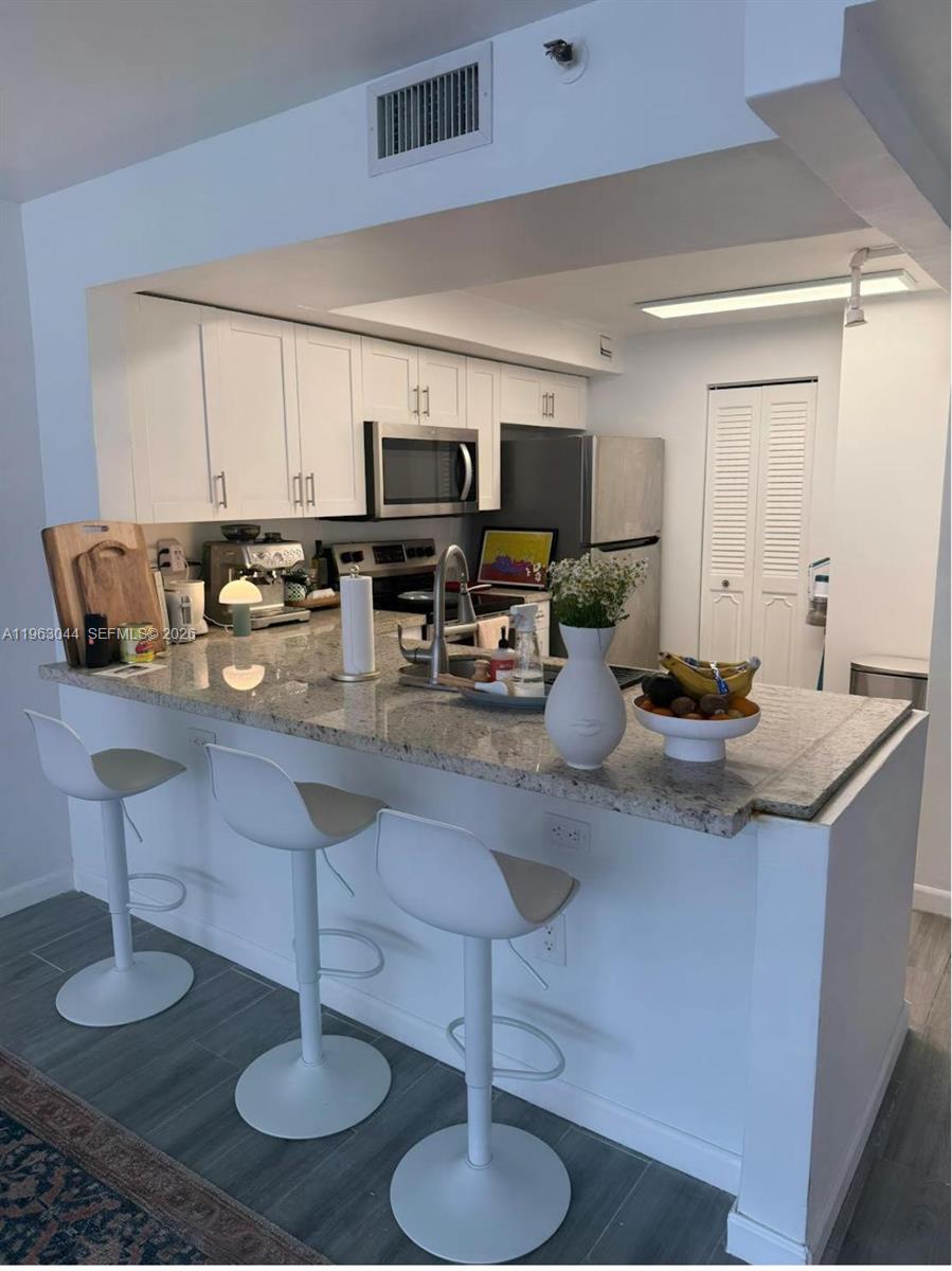 555 Northeast 15th Street, Unit 29G Miami, FL 33132 - Photo 8 of 11 a kitchen with counter space cabinets and appliances