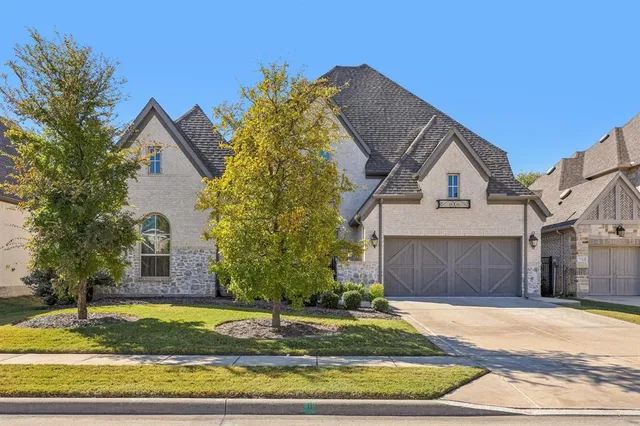 a front view of a house with a yard garage and garage