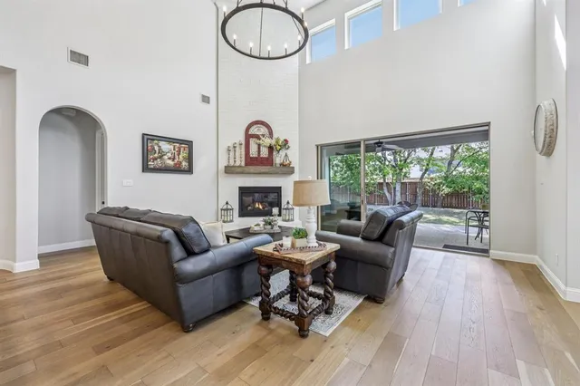 a living room with furniture a fireplace and a floor to ceiling window