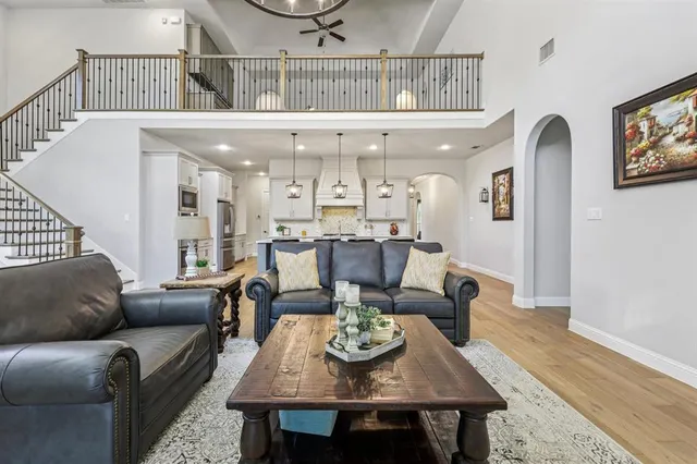a living room with furniture and a dining table