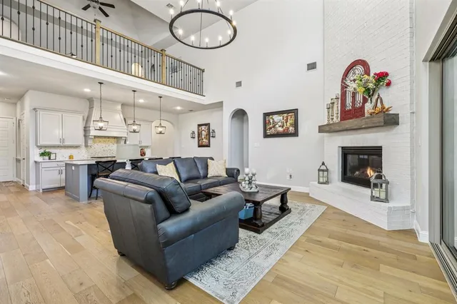 a living room with furniture kitchen view and a fireplace