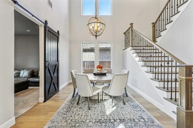 a view of a dining room with furniture wooden floor and a chandelier