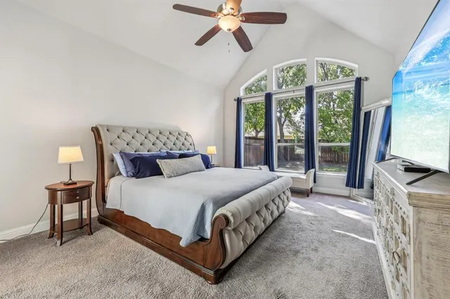 a bedroom with a bed and a large window