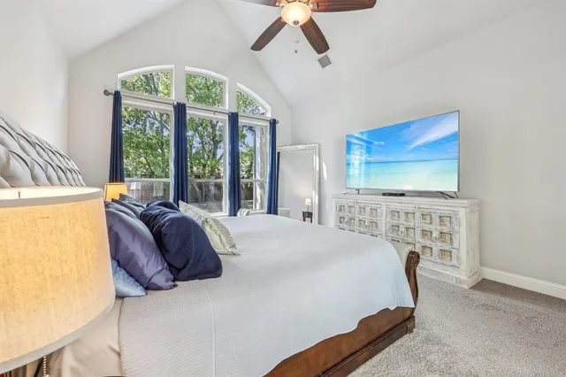 a bedroom with a bed and a large window