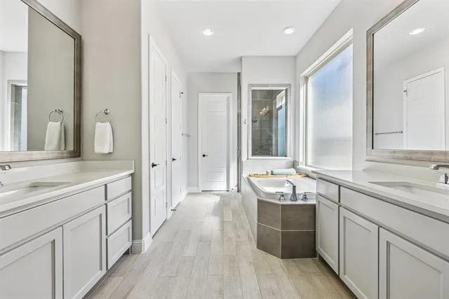 a large white kitchen with a sink and dish washer