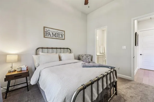 a bedroom with a bed and a night stand