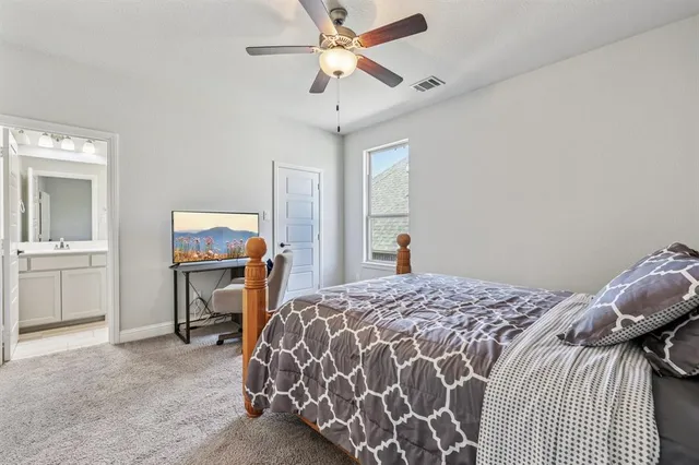 a bedroom with a bed and a tv on table