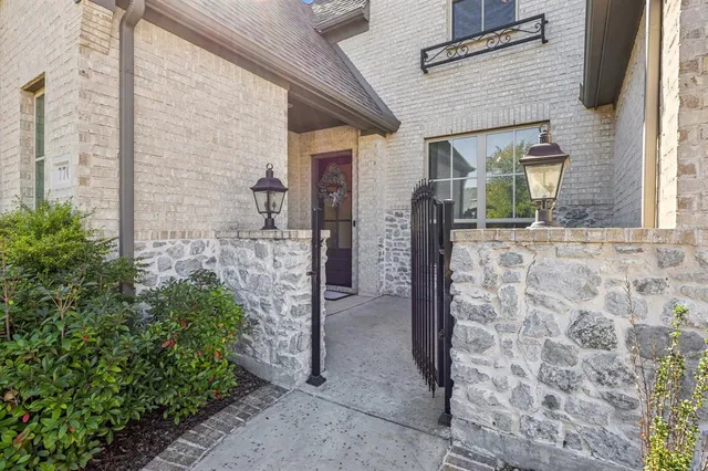 a view of a brick house with potted plants