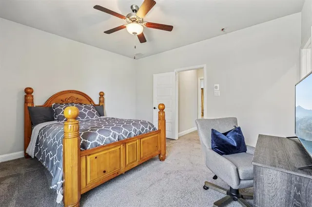 a bedroom with bed and a chandelier