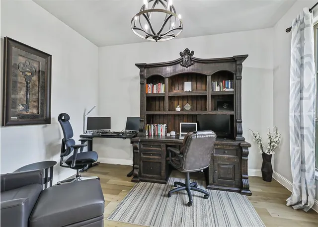 a view of a workspace with furniture and a window