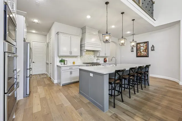 a large kitchen with a table and chairs