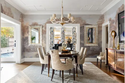 a view of a dining room with furniture wooden floor and chandelier