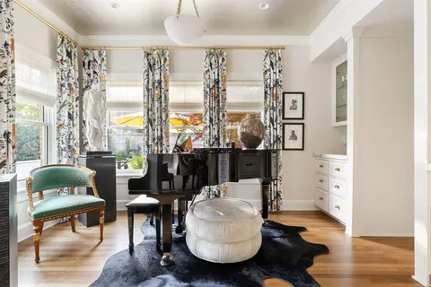 a living room with furniture and a floor to ceiling window