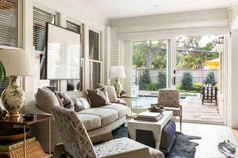 a living room with furniture and a floor to ceiling window
