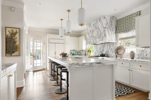 a kitchen with stainless steel appliances granite countertop a sink a stove and cabinets