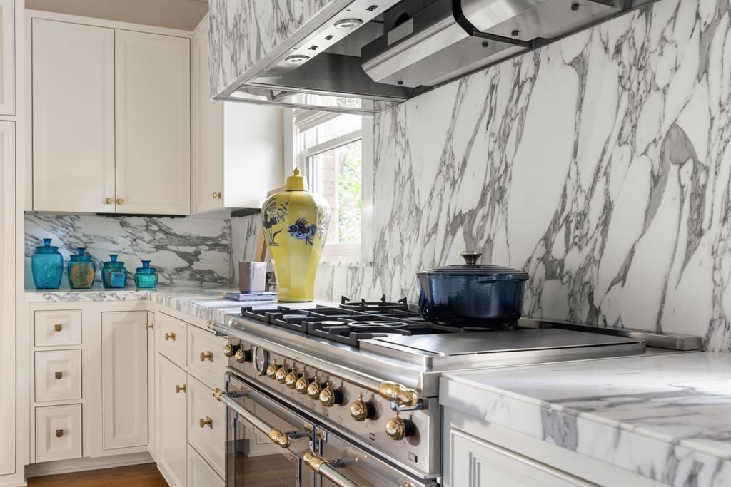 1203 North Windomere Avenue Dallas, TX 75208 - Photo 26 of 40 a kitchen with a stove and a white wooden cabinets