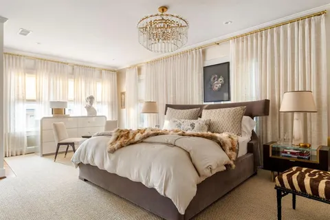 a bedroom with bed and a large window