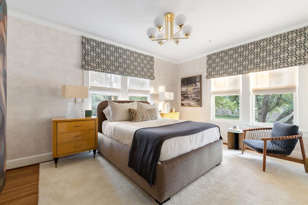 1203 North Windomere Avenue Dallas, TX 75208 - Photo 35 of 40 a spacious bedroom with a bed and a chandelier