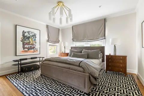 a living room with furniture a window and a chandelier