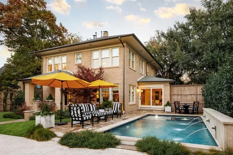 a view of a house with swimming pool and sitting area
