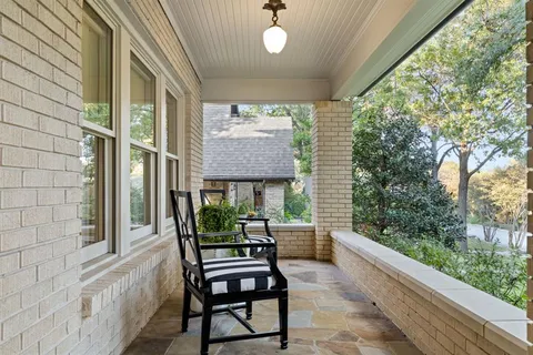 a view of a porch with furniture and garden