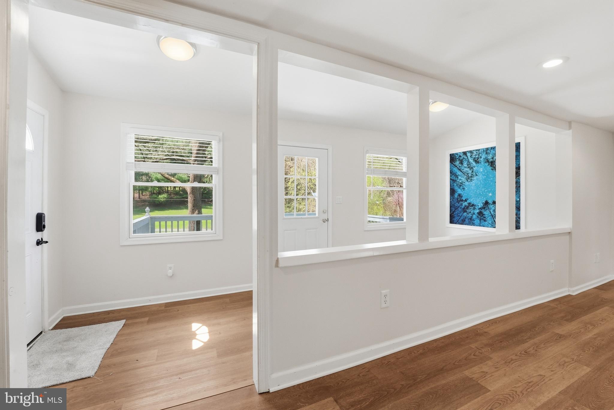 6537 Watery Mountain Road Warrenton, VA 20186 - Photo 12 of 44 an empty room with wooden floor and windows