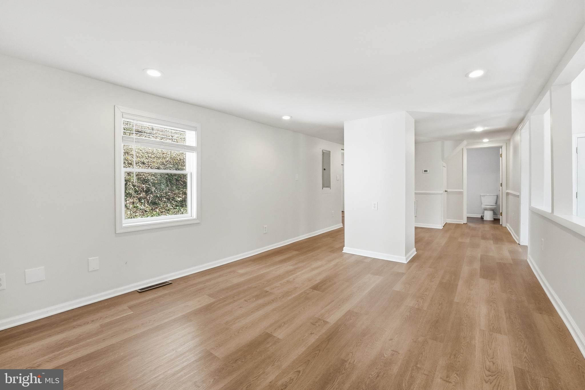 6537 Watery Mountain Road Warrenton, VA 20186 - Photo 13 of 44 an empty room with wooden floor and windows