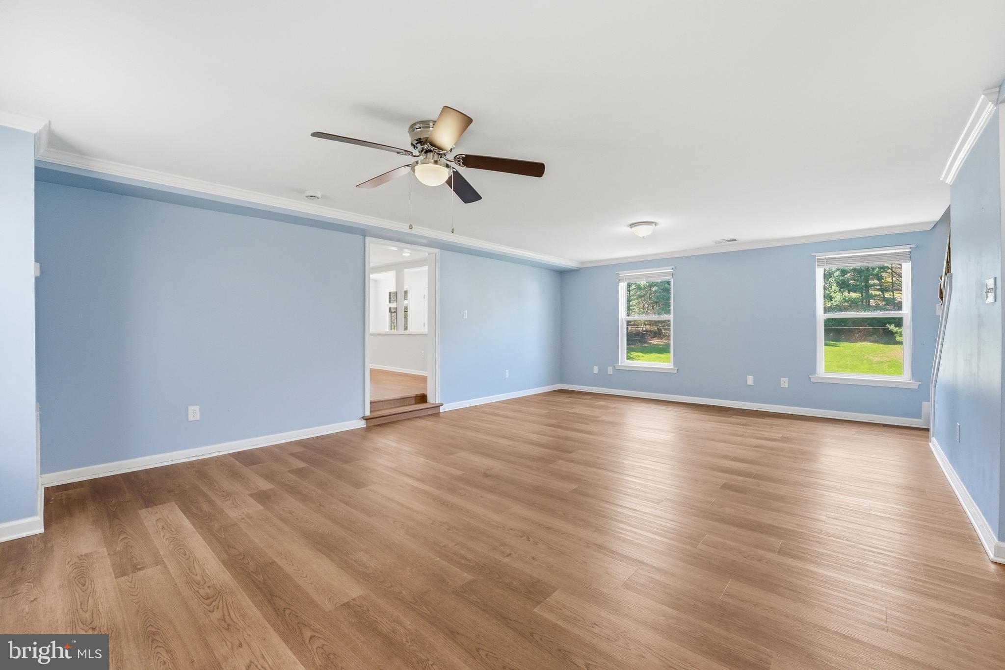 6537 Watery Mountain Road Warrenton, VA 20186 - Photo 18 of 44 a view of empty room with wooden floor and ceiling fan