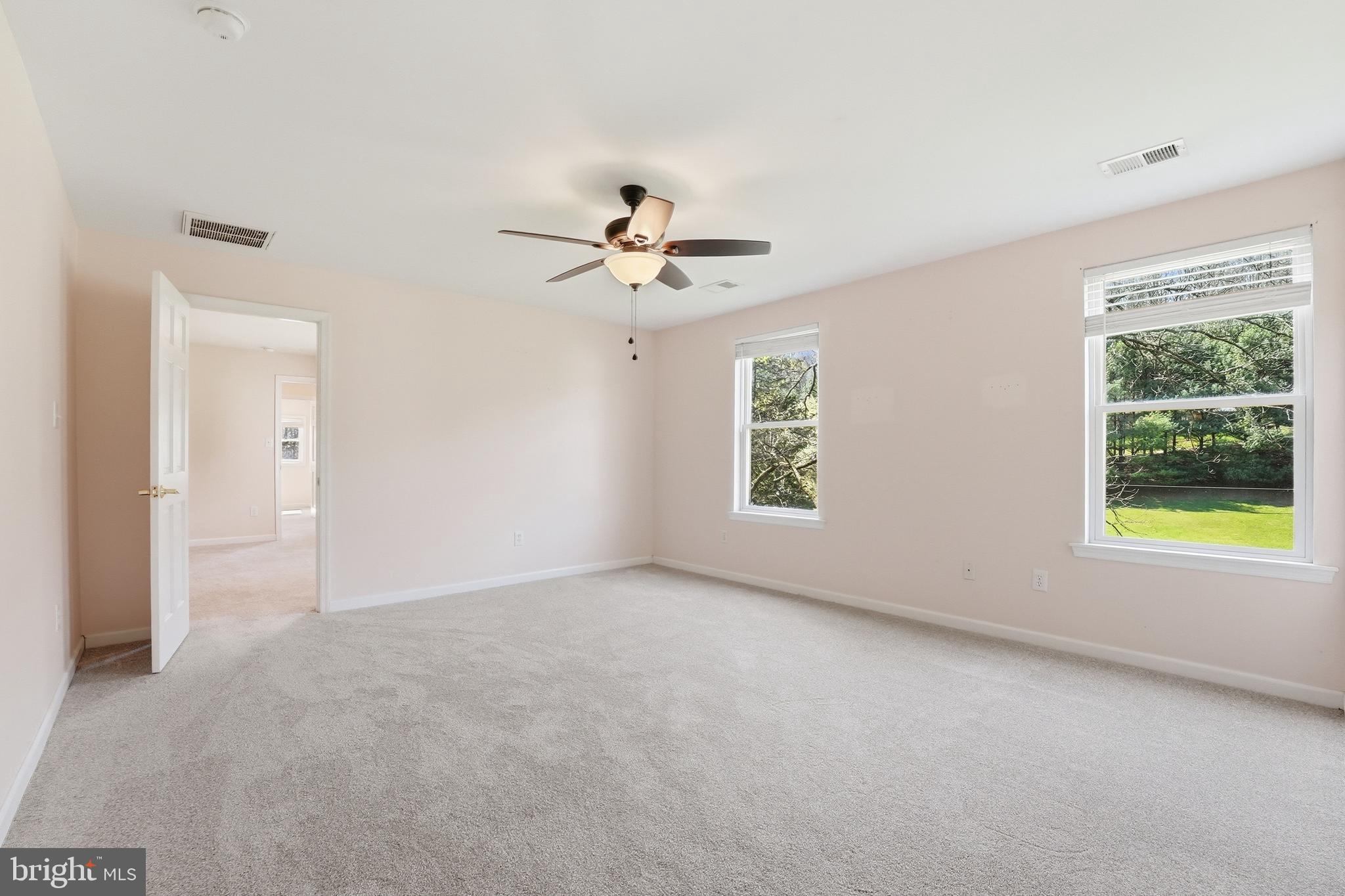 6537 Watery Mountain Road Warrenton, VA 20186 - Photo 22 of 44 an empty room with windows and chandelier fan