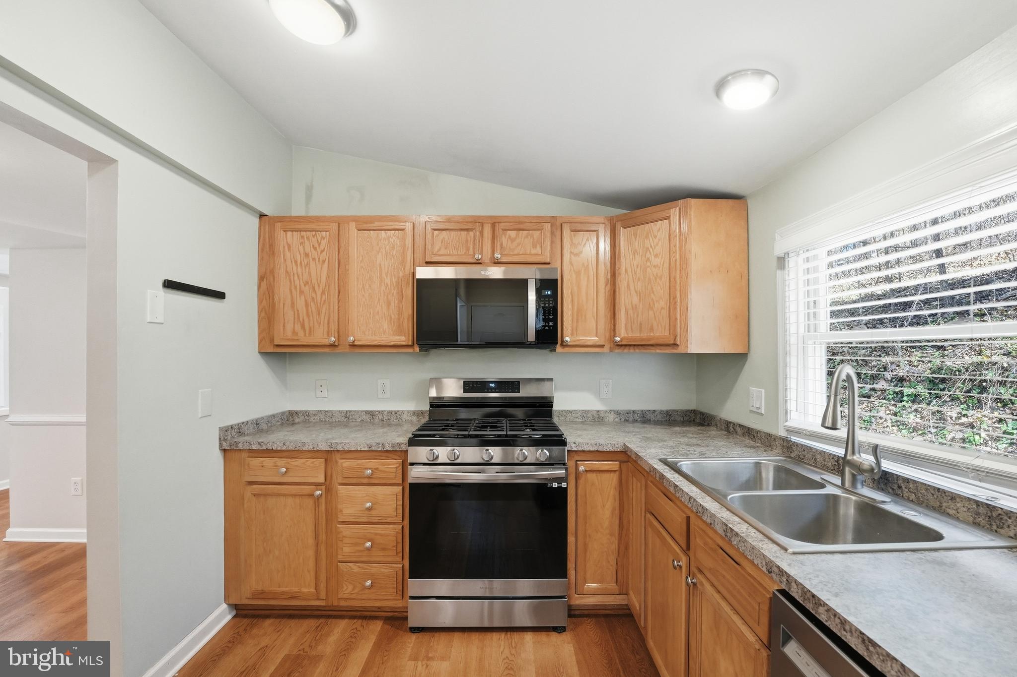 6537 Watery Mountain Road Warrenton, VA 20186 - Photo 6 of 44 a kitchen with granite countertop a sink stainless steel appliances and cabinets