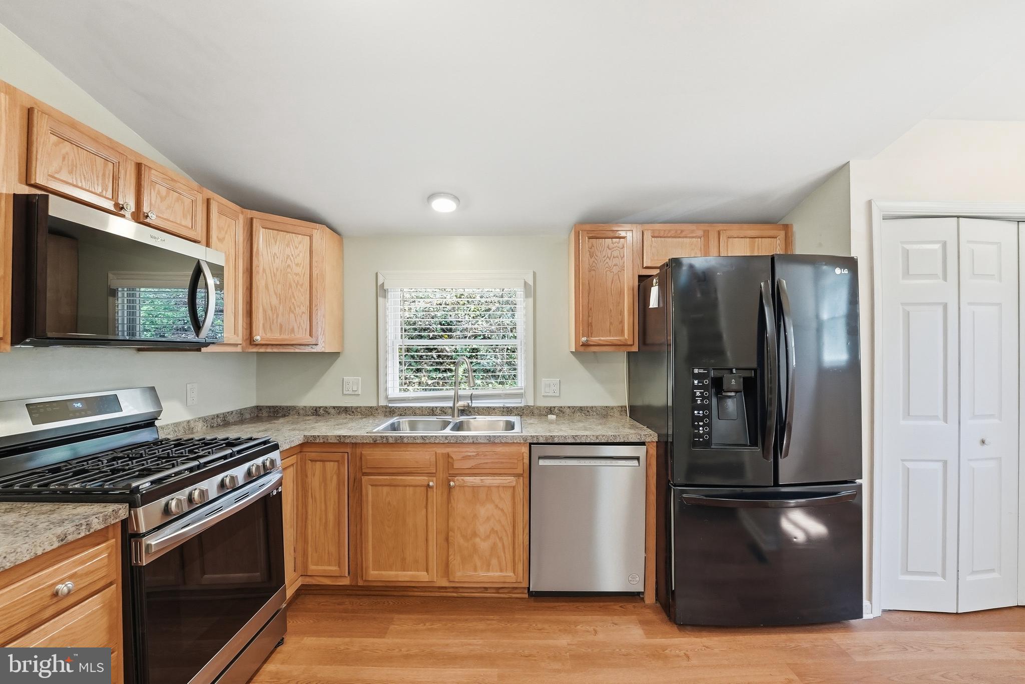6537 Watery Mountain Road Warrenton, VA 20186 - Photo 7 of 44 a kitchen with stainless steel appliances granite countertop a refrigerator stove top oven and sink