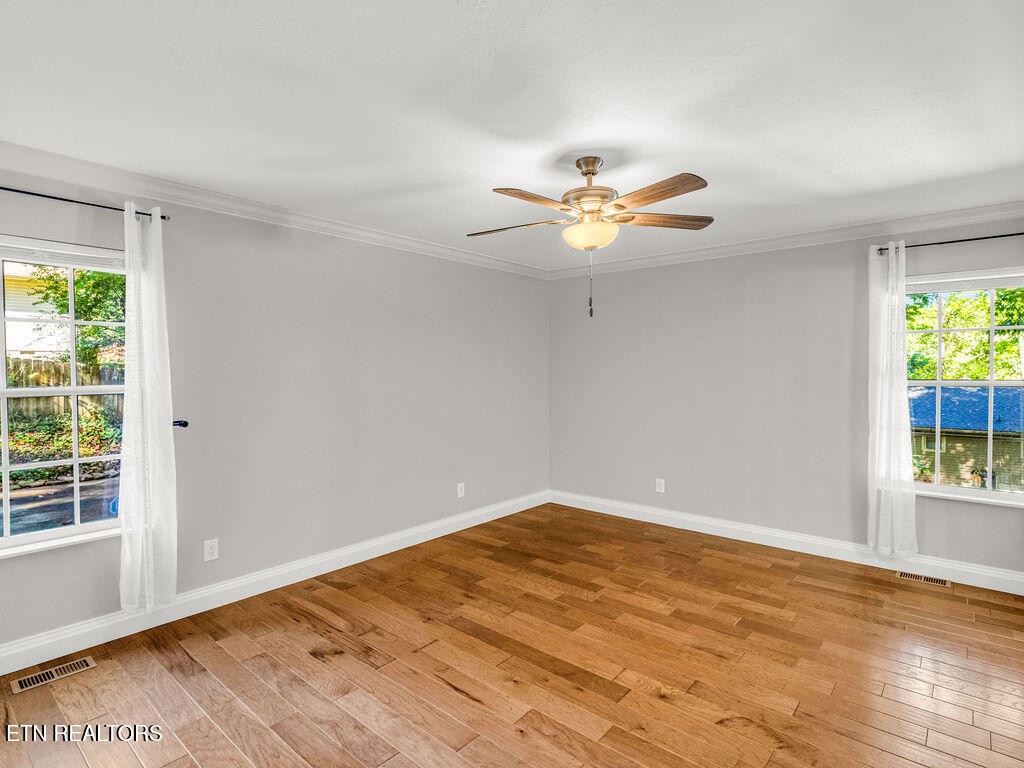 170 Cedar Circle Powell, TN 37849 - Photo 10 of 27 an empty room with wooden floor and chandelier fan