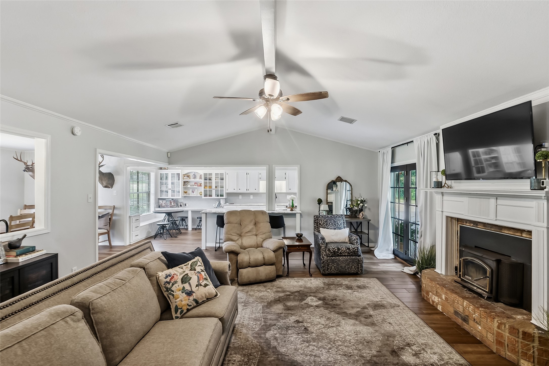 906 Standley Road Madisonville, TX 77864 - Photo 5 of 40 a living room with furniture a fireplace and a flat screen tv