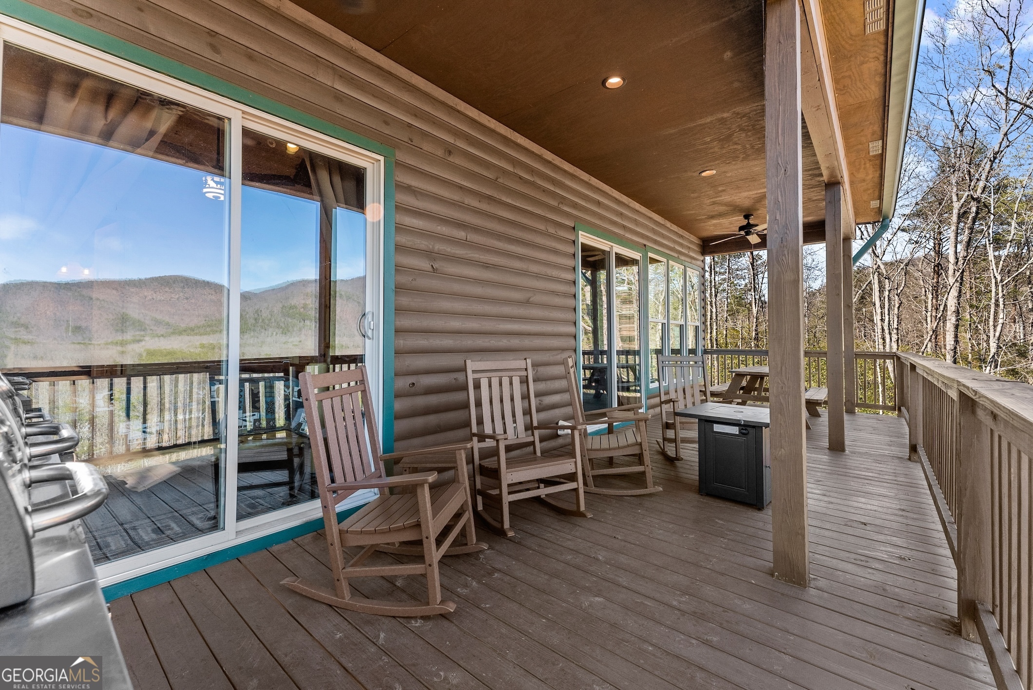 473 Monroe Ridge Road Sautee Nacoochee, GA 30571 - Photo 33 of 63 a view of a chairs and table on the deck with wooden floor