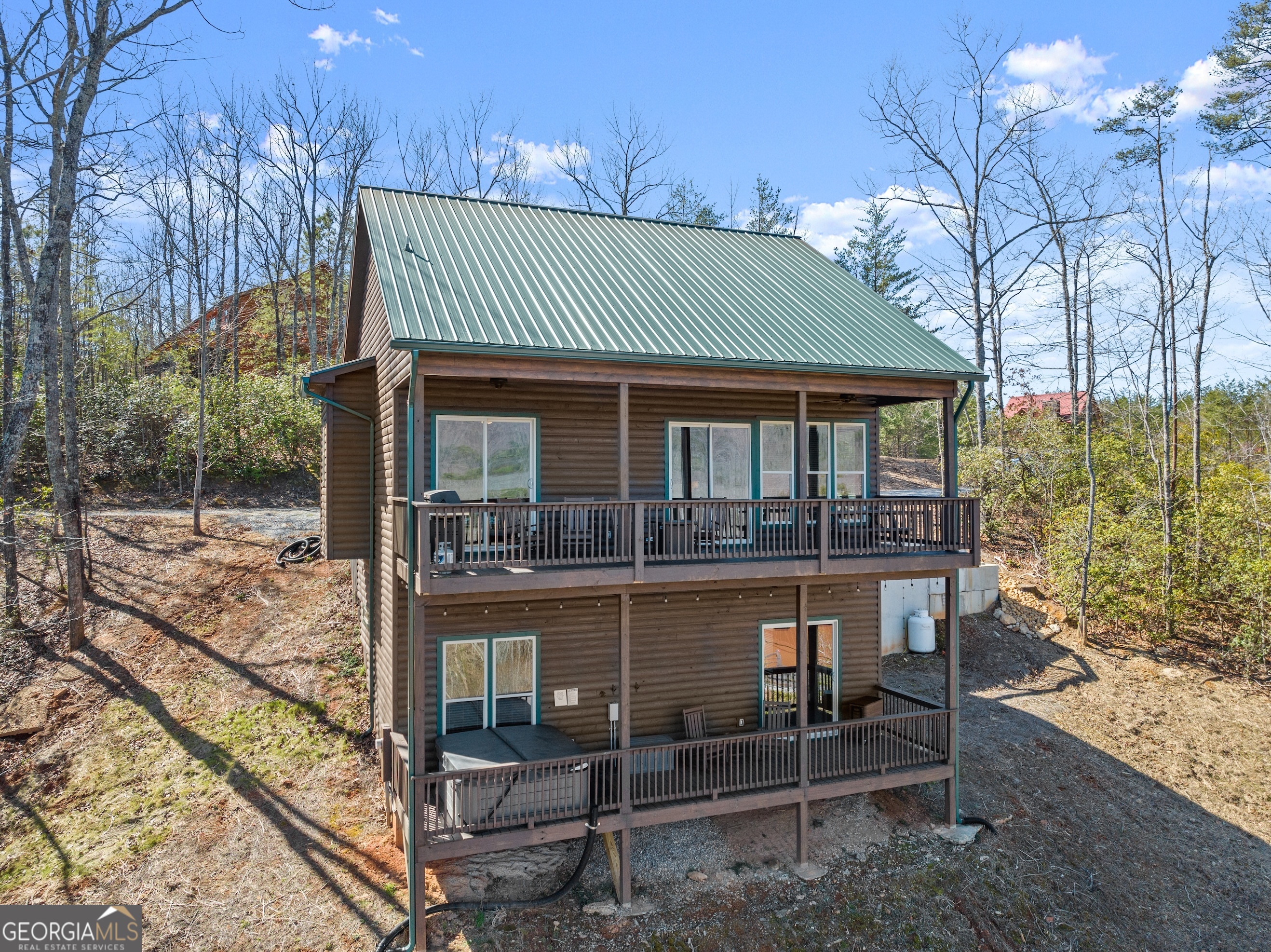 473 Monroe Ridge Road Sautee Nacoochee, GA 30571 - Photo 38 of 63 a front view of a house with a porch