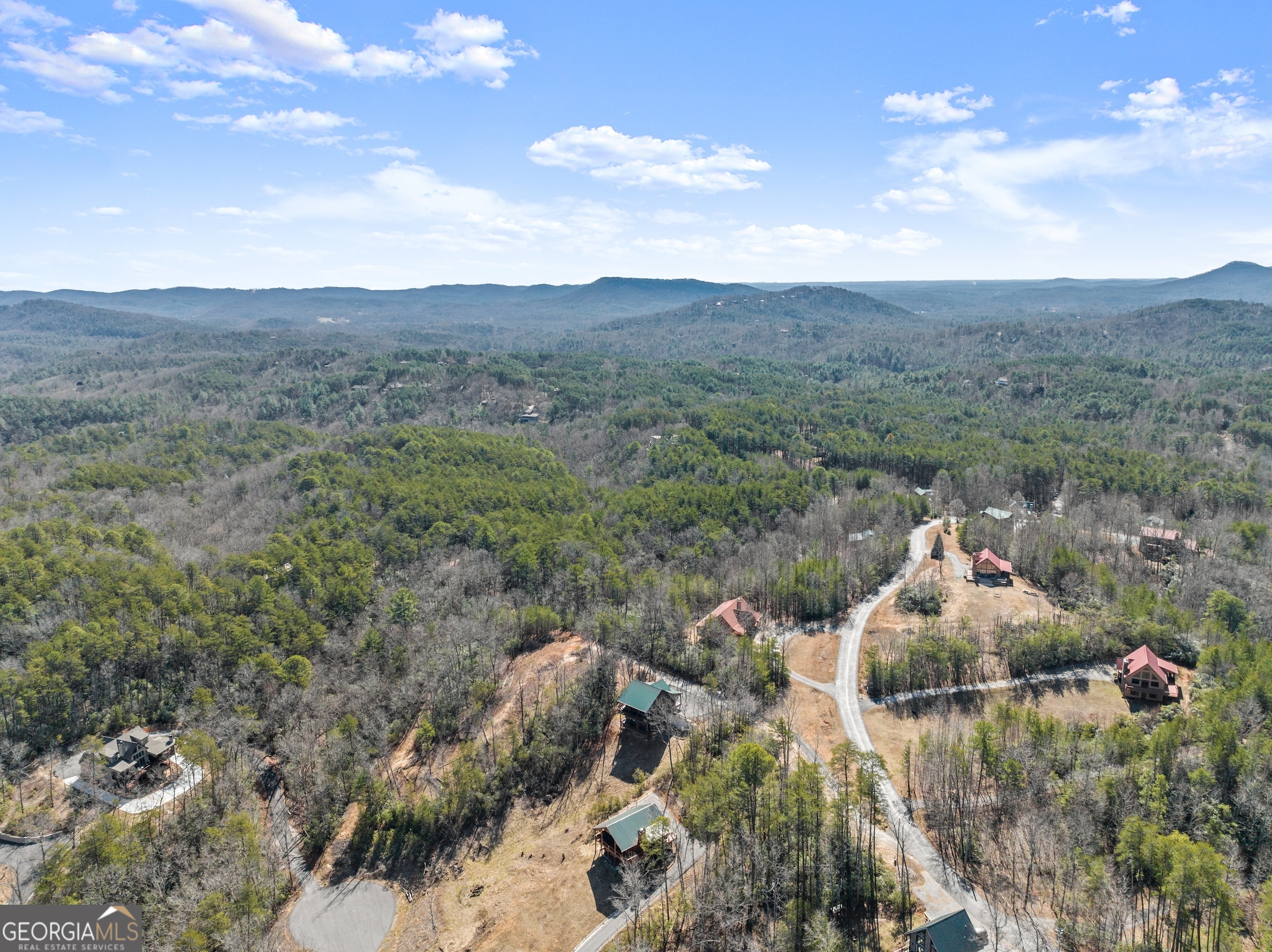 473 Monroe Ridge Road Sautee Nacoochee, GA 30571 - Photo 40 of 63 a backyard of a house with table and chairs