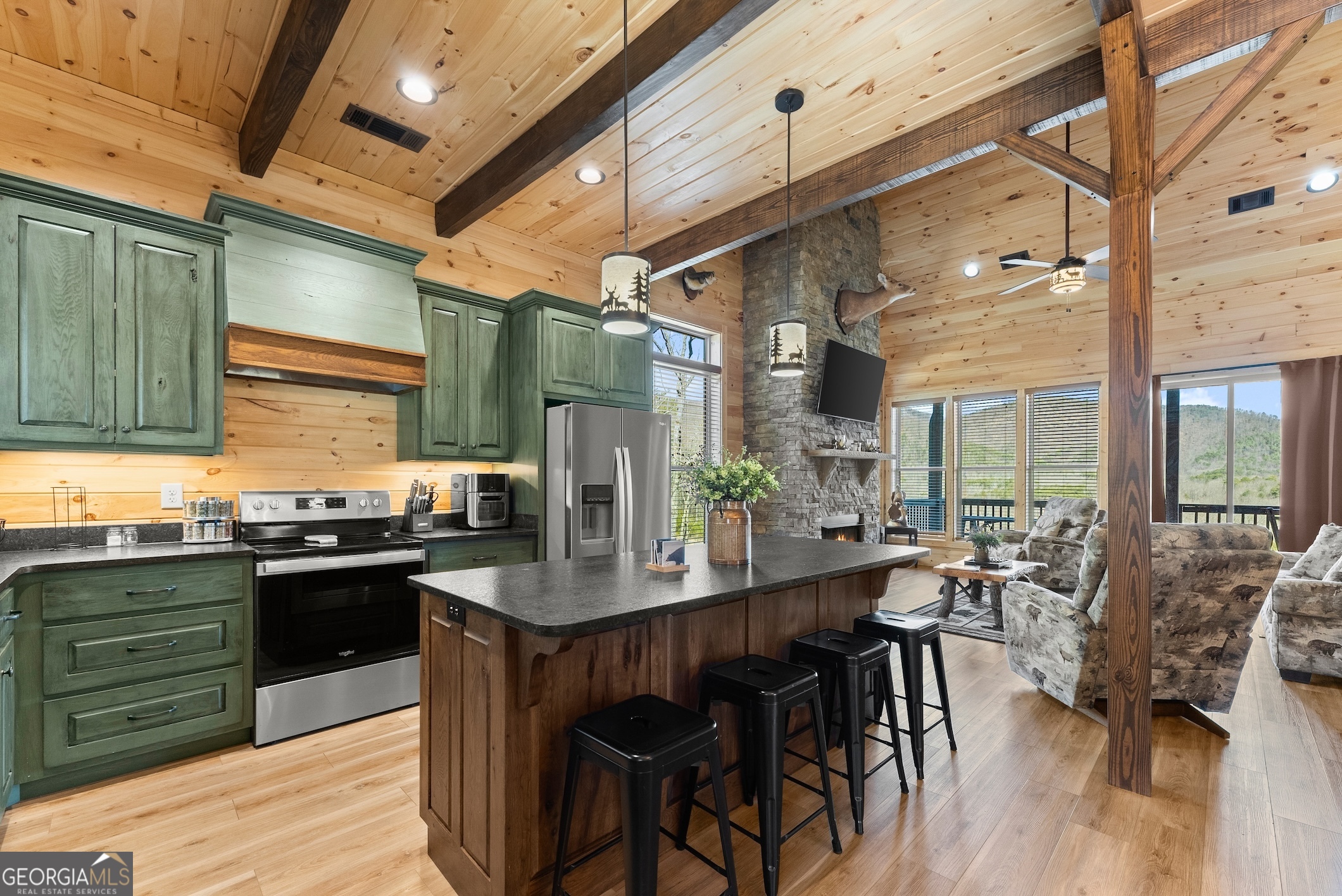 473 Monroe Ridge Road Sautee Nacoochee, GA 30571 - Photo 4 of 63 a kitchen with stainless steel appliances granite countertop a table chairs stove and refrigerator