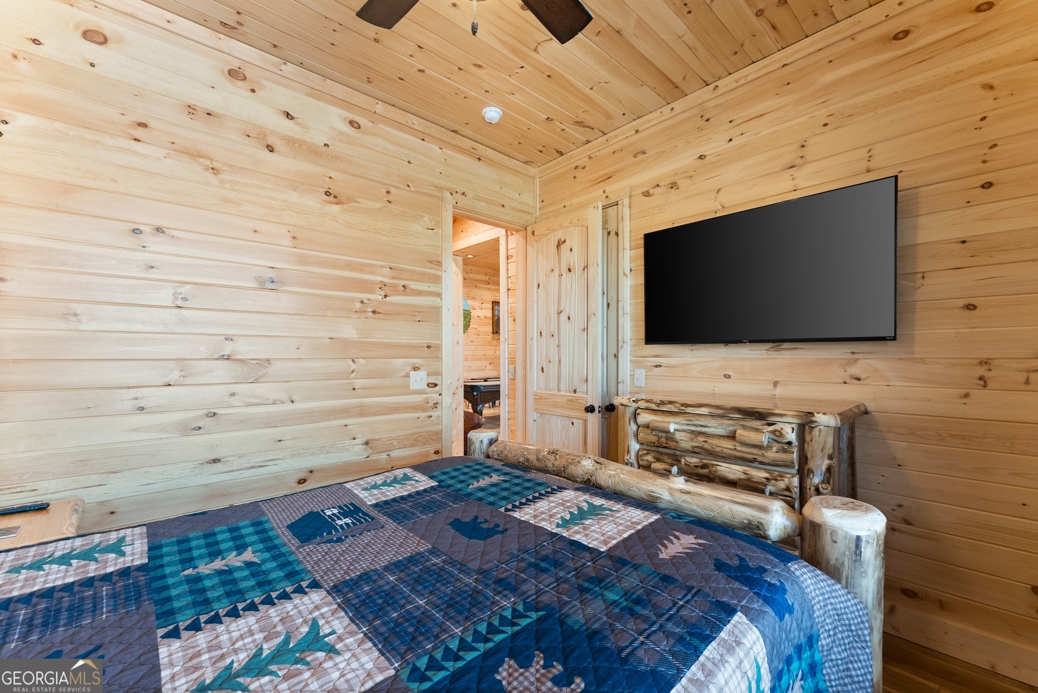 473 Monroe Ridge Road Sautee Nacoochee, GA 30571 - Photo 48 of 63 a bedroom with a bed and a flat screen tv