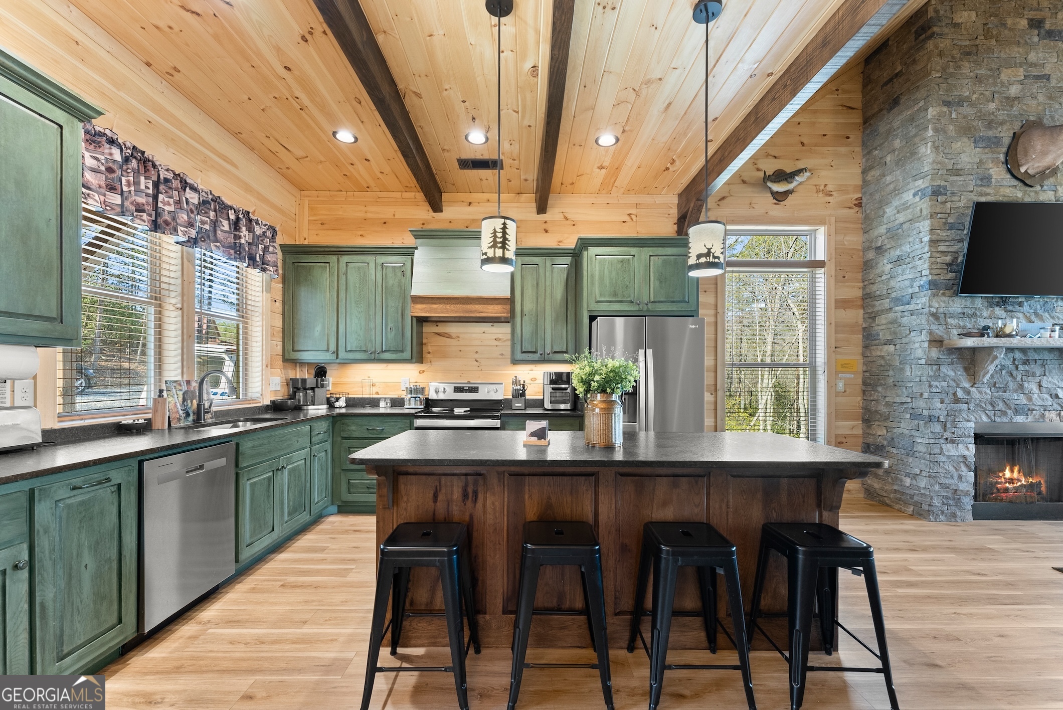 473 Monroe Ridge Road Sautee Nacoochee, GA 30571 - Photo 56 of 63 a kitchen with stainless steel appliances granite countertop a table chairs stove and sink