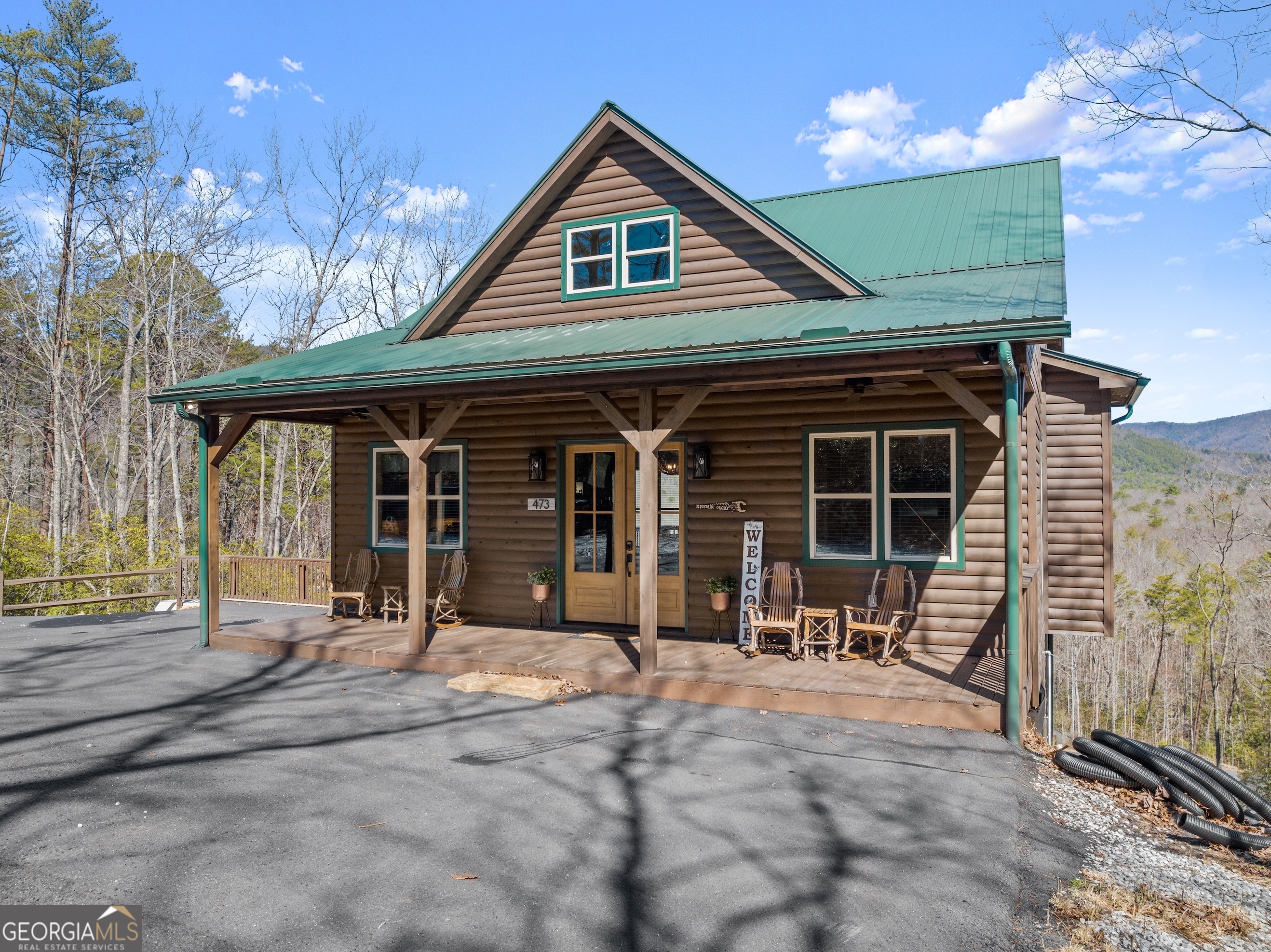 473 Monroe Ridge Road Sautee Nacoochee, GA 30571 - Photo 58 of 63 a front view of a house with garden and seating space