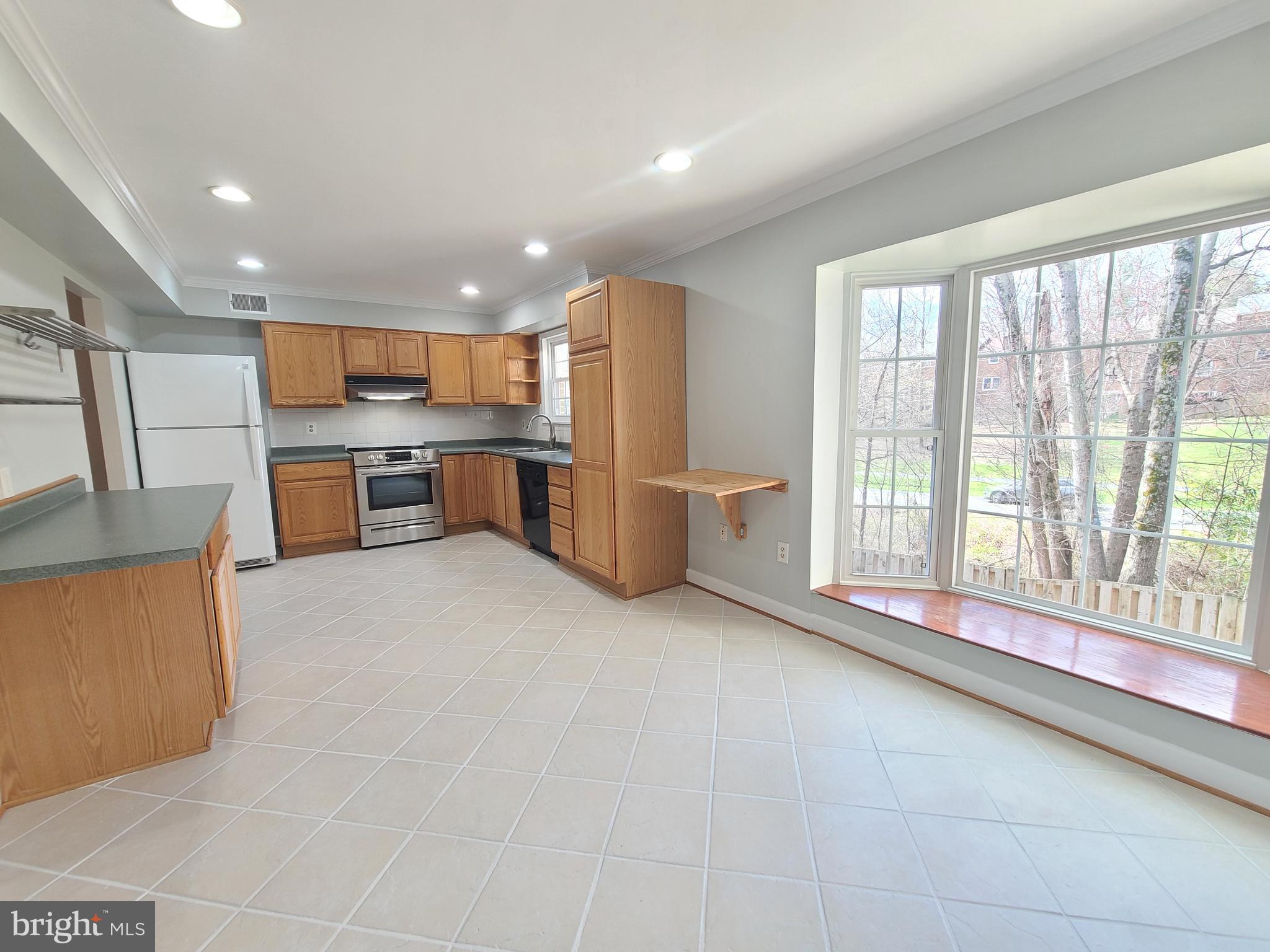 6644 Green Ash Drive Springfield, VA 22152 - Photo 12 of 42 a large kitchen with a large counter top appliances and cabinets